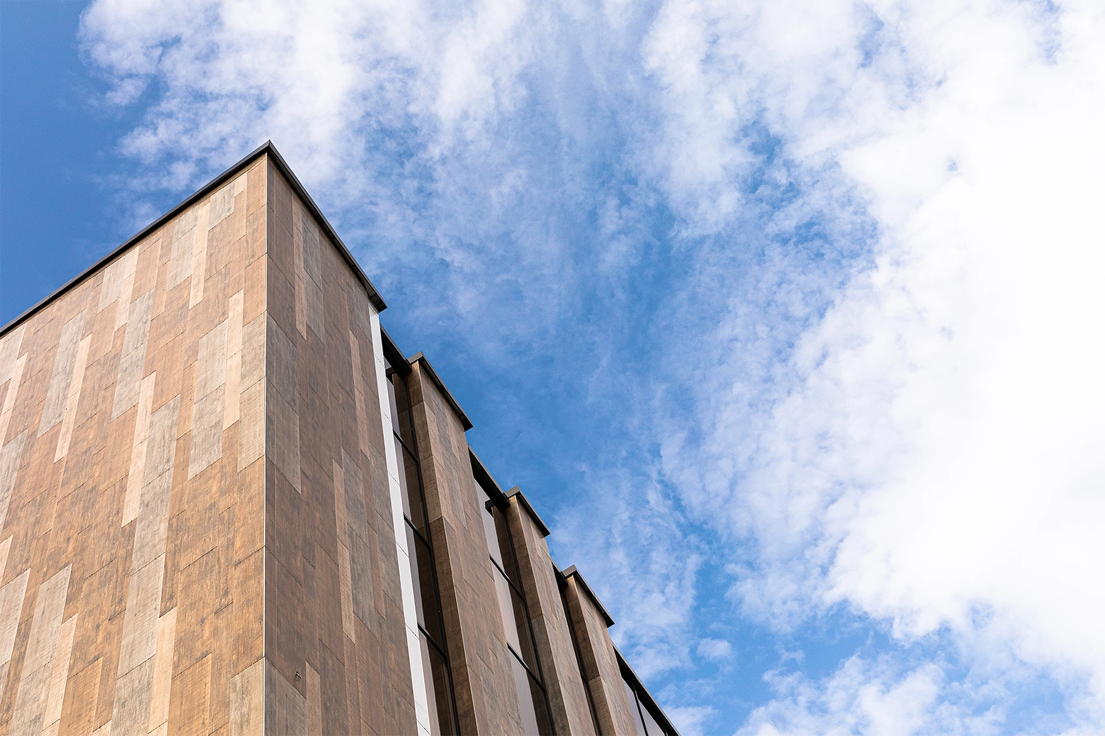 Modern office building in front of a blue sky as a symbol of recruiting in the real estate industry